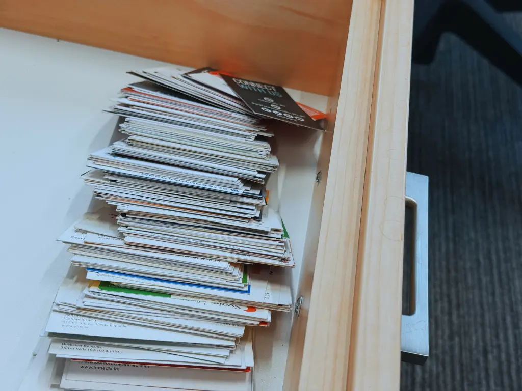 Desk drawer full of business cards